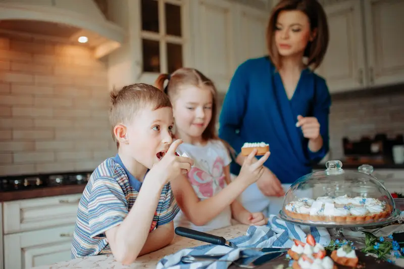 Family baking together in kitchen interior