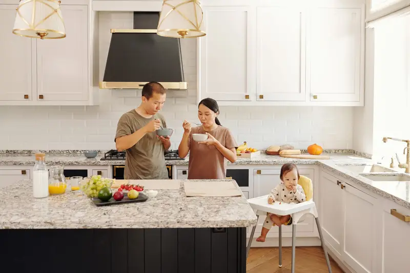 Family lifestyle moment in kitchen with blue cabinets